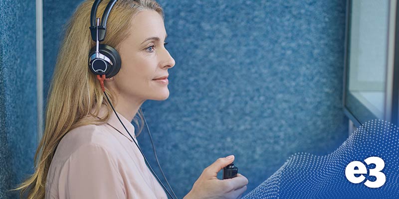 pure tone audiometry woman testing in a booth