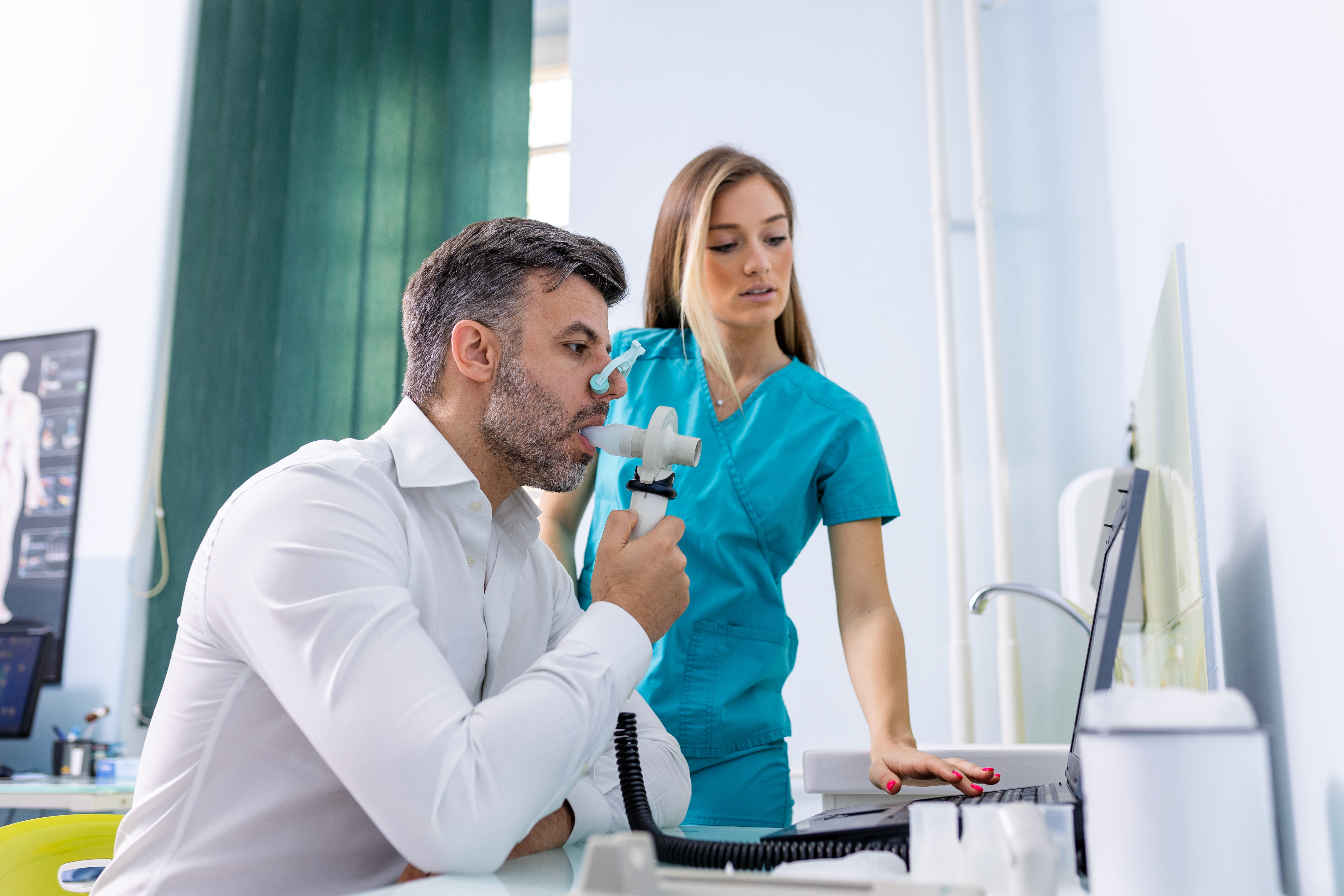 man being tested on a spirometry device