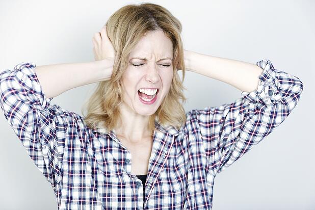 young-woman-holding-her-head-looking-pained-and-upset