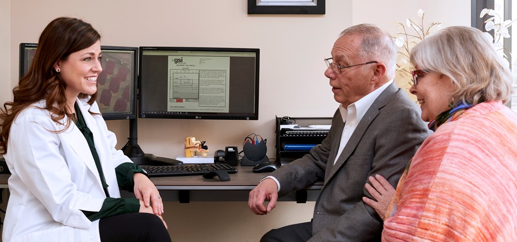 An audiologist reviewing automated audiometry results with patients