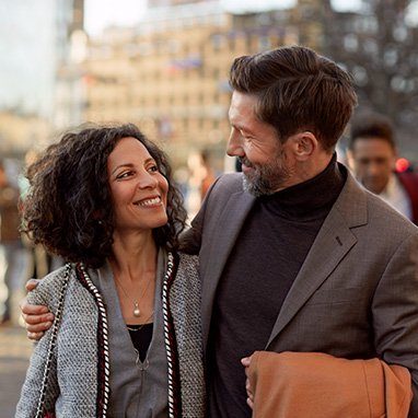 Man wearing Opn S hearing aids talking with woman